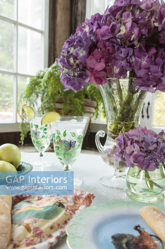  â€œI love hydrangeas. They are so New England!â€ Ellen says. Bouquets of purple blooms adorn antique flea-market vases. 