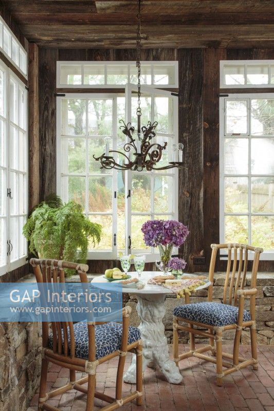 Light streams from many windows to fill the living room, once an old brick porch housing orchids in winter. 
The cozy corner table offers a quiet spot for breakfast or tea for two. 