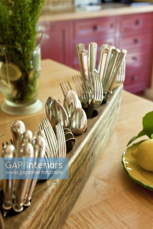 An old sugar mold makes a sweet utensil holder. 