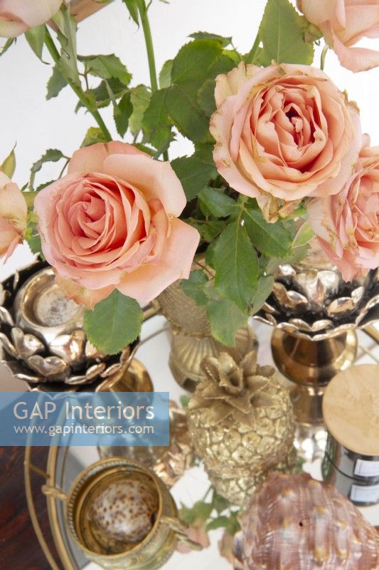 Roses on a glass tray with brass ornaments