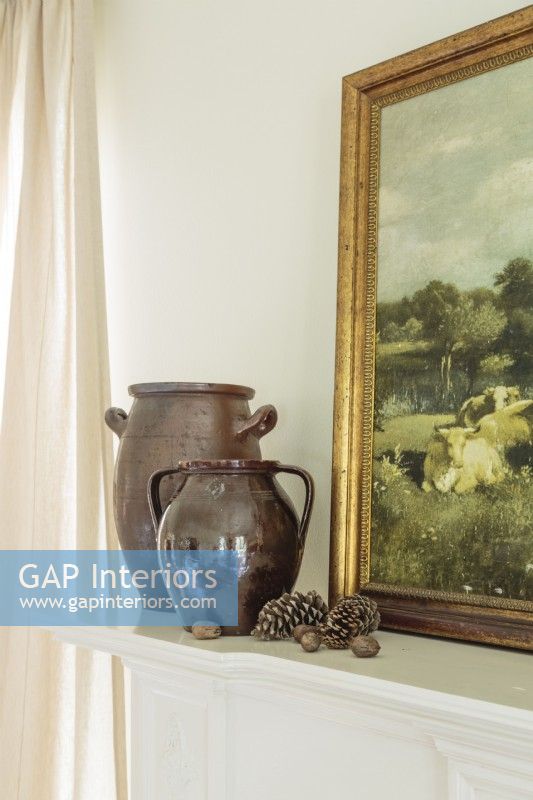 A pair of urns contributes a quiet sculptural touch, while pines cones speak of the farmhouseâ€™s location.