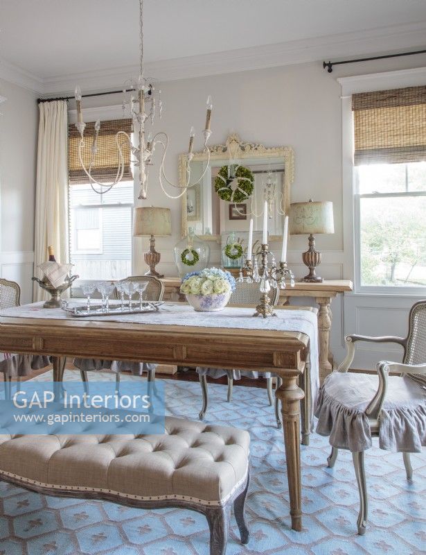 Anita employed harmonious grays and blues to give her dining room a serene appeal. The walls soft color forms a serene backdrop while gunmetal gray linen graces the ruffle-skirted chair cushions.