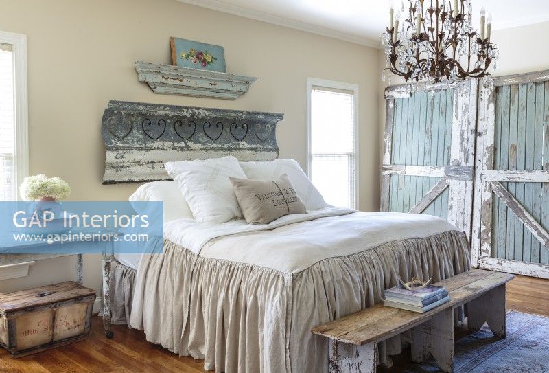Rather than use decoratorâ€™s tricks such as dark-colored walls to minimize large rooms, Kathee creates impressions of even more space by keeping walls light.Leaning architectural salvage infuses the master bedroom with weathered allure