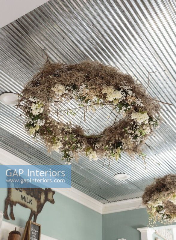 Rather than hung on a wall, wreathes are suspended from the ceiling.