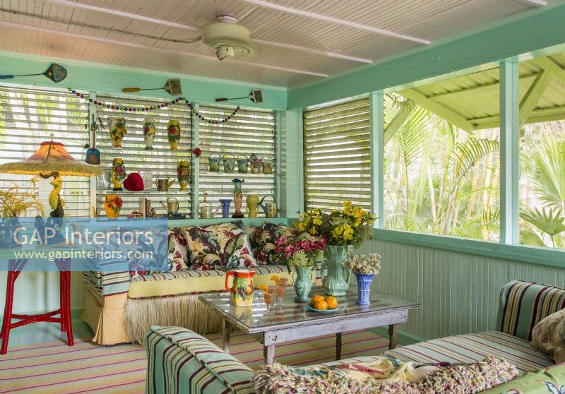 Shades of aqua and turquoise dominate and harmonize with the outdoor greenery.