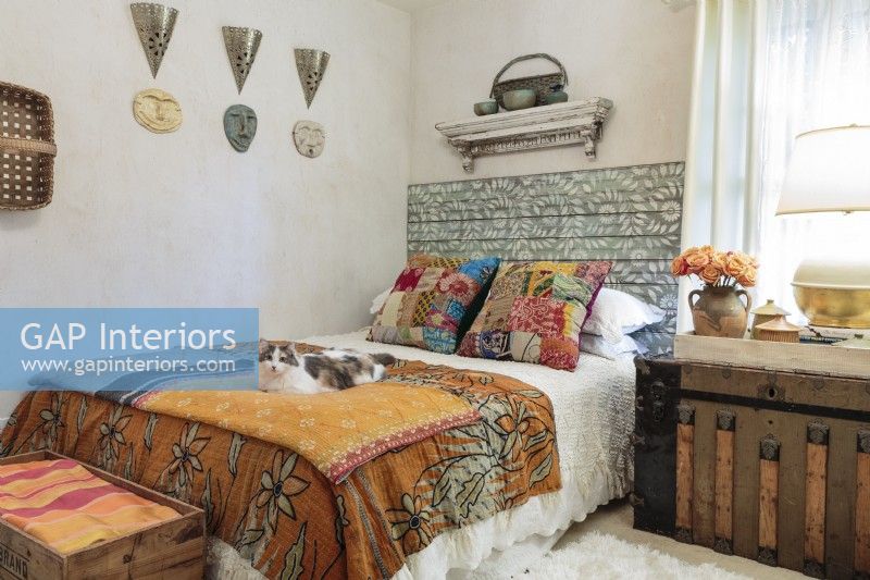 A mix of linens and objects from far-away-lands give the guest room a carefree caravan vibe.
