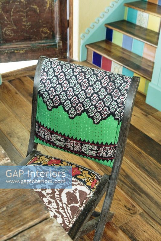 Folding chairs are upholstered in a myriad of tribal patterns. 