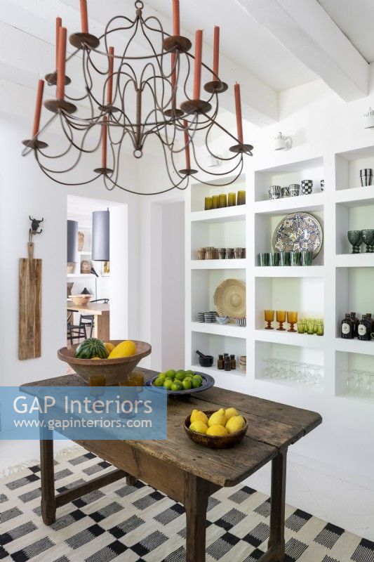 Glassware displayed on wall shelves in country kitchen