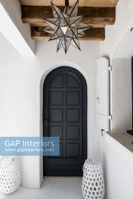 Black painted wooden door with white wall surround
