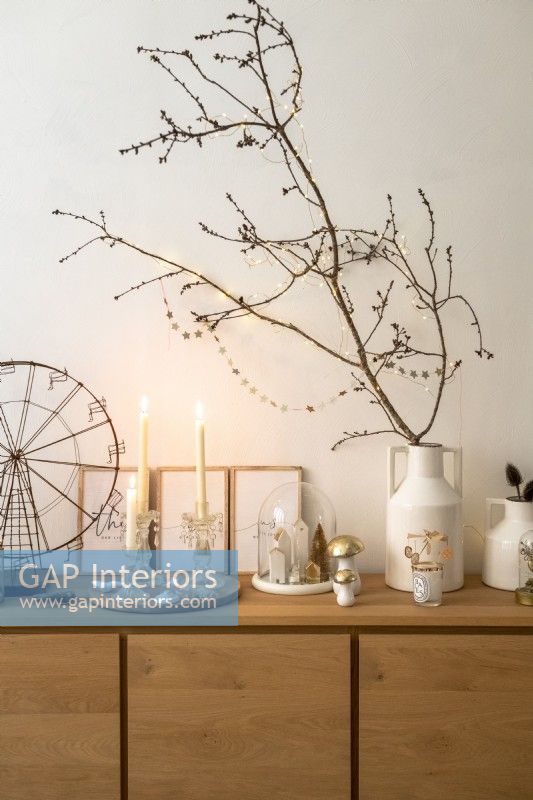 Bare branches decorated with fairy lights for Christmas