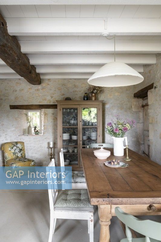 Vintage furniture and stone wall in country dining room