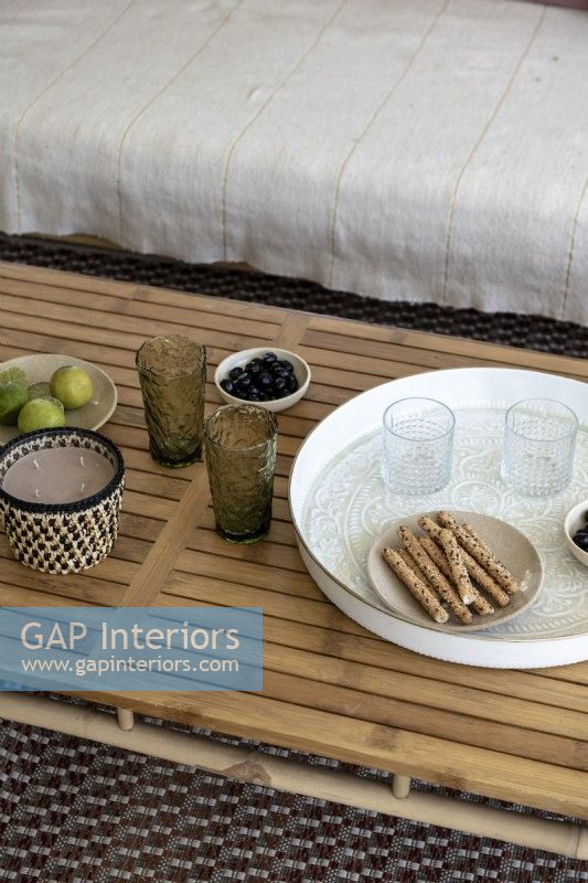 Snacks and drinks on wooden table - detail