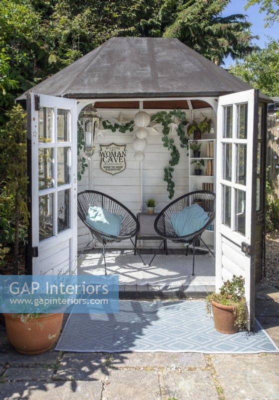 Modern chairs in small summerhouse