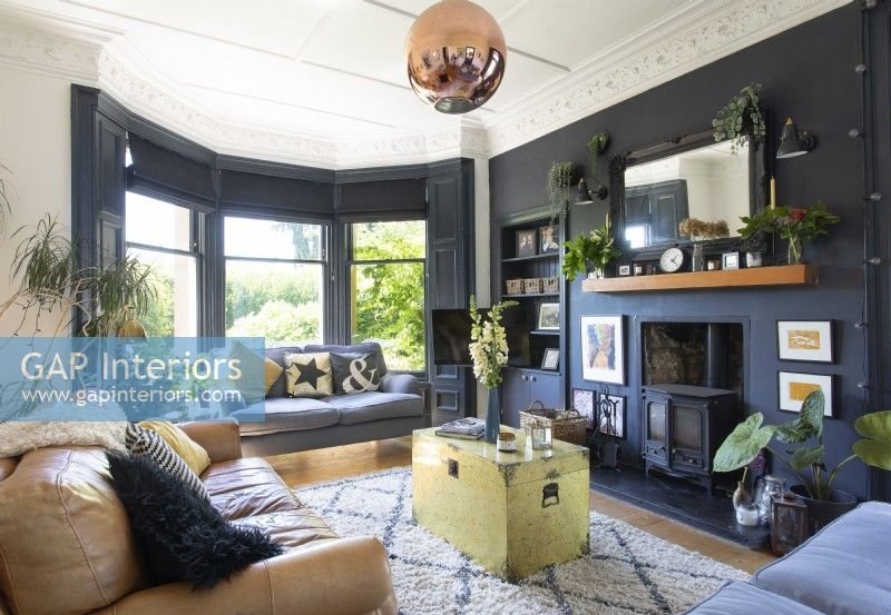 Modern living room with dark grey walls and period features