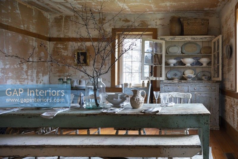 Country dining room with distressed painted walls and rustic furniture