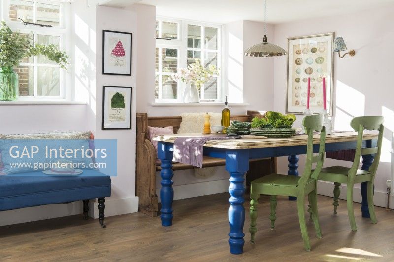 Blue and green painted wooden furniture in country dining room