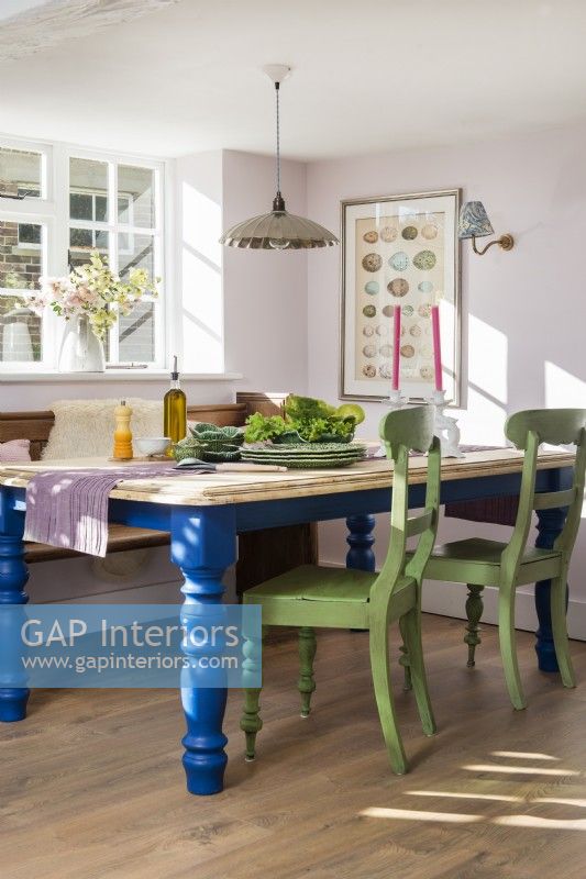 Blue and green painted furniture in country dining room