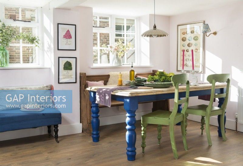 Green and blue painted table and chairs in country dining room