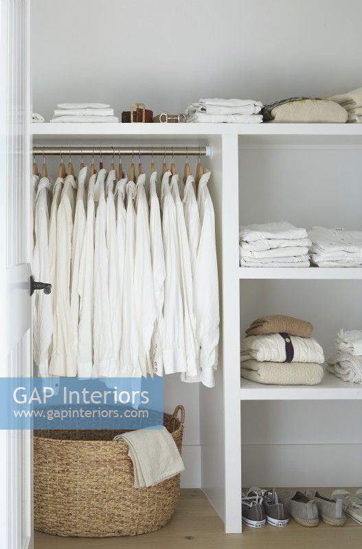 Closet with open shelving and white clothes