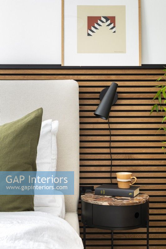 Upholstered headboard with slatted wall paneling.