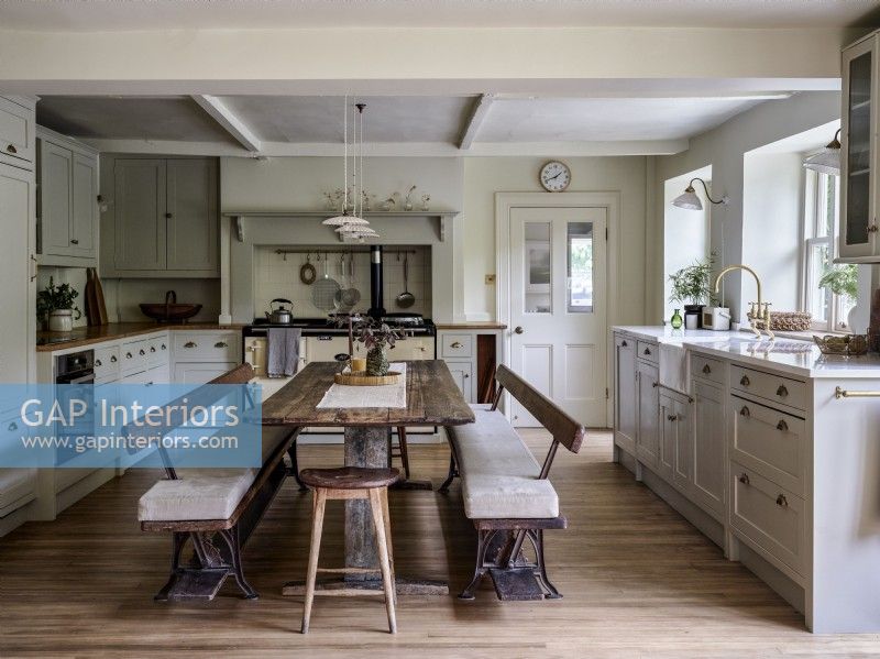 Neutral kitchen with reclaimed dining table and bench seating
