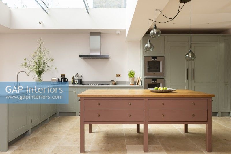 Contemporary classic kitchen with large freestanding pink island.