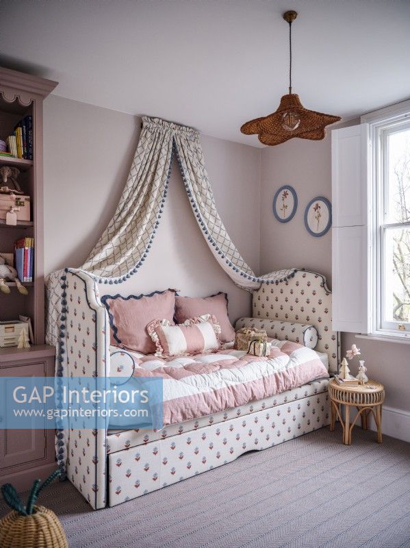 Upholstered daybed with canopy drapes 
