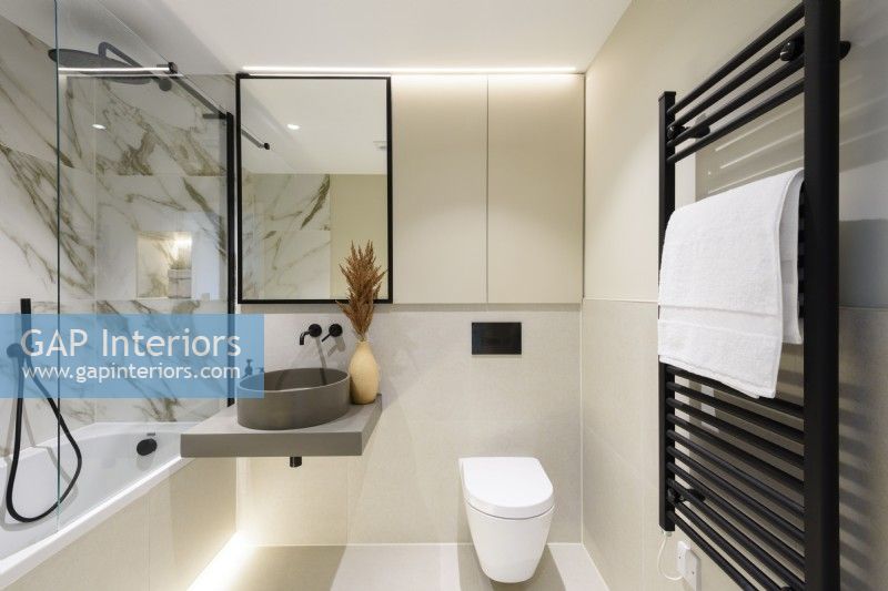 Modern bathroom with marble walls and black fittings