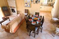 Corfu, Greece. Malama House near Barbati. Open plan Living and dining room with table and chairs set for dining. Water melons on table