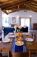 Villa Christina, Kaminaki, Corfu, Greece. Open plan living and dining room with table setting