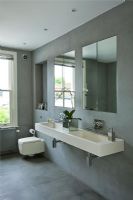 Modern bathroom with wall mounted double stone sink in grey slate tiled bathroom  twin with mirrors
