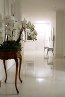 Classic white hallway wit console table and marble floor