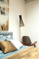 Contemporary bedroom with Seppo Koho Lamp and shell chair