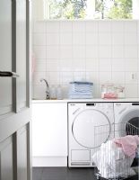 Modern kitchen with washing machine and tumble dryer
