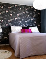 Modern bedroom with wallpapered walls 