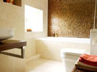 View to modern bathroom with mosaic tiled feature wall