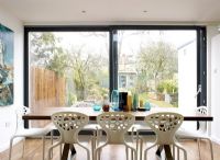 Modern dining room with  patio doors and view to garden