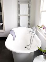 Modern bathroom with freestanding roll top bath 