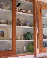 Trinkets on display in kitchen cupboard