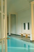 View of indoor swimming pool through open doorway
