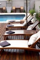 Row of sunloungers on poolside