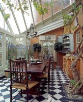 Wooden dining table and chairs in conservatory