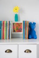 Books on chest of drawers in childrens room