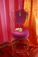 Flowers on chair with curtain behind
