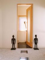 Ethnic sculptures on either side of an open door