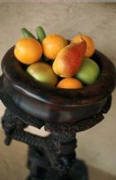 Ornate wooden bowl full of fruit