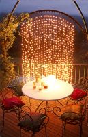 Deck patio illuminated by Christmas lights