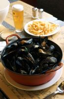 A dutch oven full of mussels