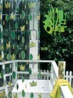 Outdoor shower with leaf pattern shower curtain