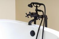 Detail of tub faucet and knobs with detachable shower head